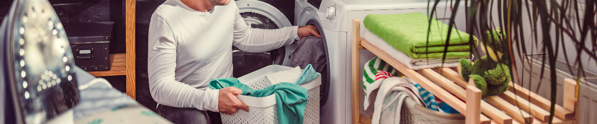 Cuidur - Hombre poniendo ropa en la lavadora